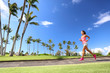 © Maridav - Girl jogging in park living an active summer. Runner woman running on sidewalk, healthy lifestyle.