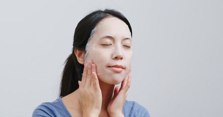 Wall Mural - Woman apply face mask on face at home