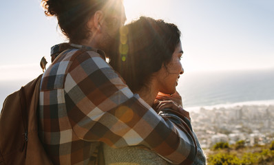 Wall Mural - Affectionate young couple admiring the view