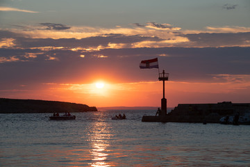 Wall Mural - Croatian flag flying in wind at sunset in harbor