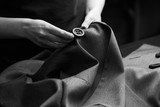 Fototapeta Konie - Sewing the buttons to the jacket