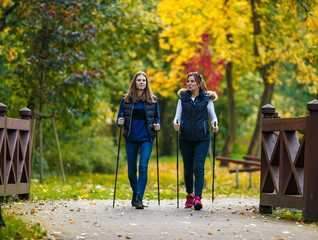 Nordic walking - active people working out in park