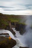 Fototapeta Tęcza - Woman stay on waterfall in Iceland, hide waterfall in Iceland, amazing sights and places to explore