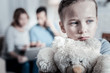 © zinkevych - Feeling sad. Upset kid looking aside while hugging a teady bear