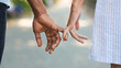 © Prostock-studio - Loving couple holding little fingers while walking