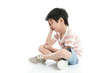 © lalalululala - Close up of sad Asian boy sitting on white background isolated