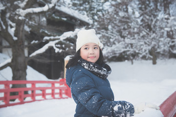 Portrait of beautiful Asian girl on red bridge at Hirosaki Castle in Aomori, Japan