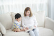 © lalalululala - Asian mother Sitting With Son Reading Story together