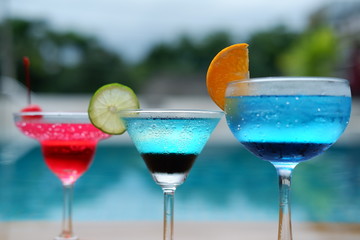 summer alcoholic drinks and cocktails at poolside bar