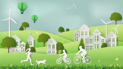 Paper folding art origami style vector illustration. Green sustainable energy ecology development concept Father & son riding bicycle, mother & dog jogging in village parks which full of wind turbine.