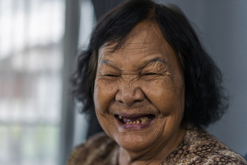 Wall Mural - senior woman laughing in living room