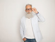 © lashkhidzetim - Cheerful happy mature man in glasses looking camera and smiling over white wall