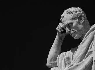 Man statue in the act of thinking. Ancient Roman Julian the Jurist statue made at the end of 19th century in front of the Old Palace of Justice in Rome (Black and White with copy space)