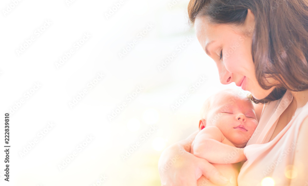 Mother and her newborn baby together. Happy mother and baby kissing and hugging. Maternity concept. Parenthood - obrazy, fototapety, plakaty 