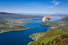 Lake Annecy (Lac Annecy) In French Apls, France. View Of The Annecy Lake From Col Du Forclaz. Paragliders With Parapente Jumping Of Col De Forclaz Near Annecy In French Alps, In France.