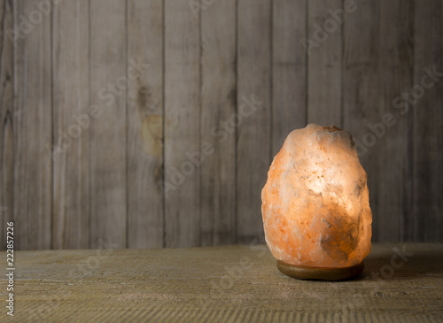 Electrical Himalayan Pink Rock Salt Lamp Turned On On Brown
