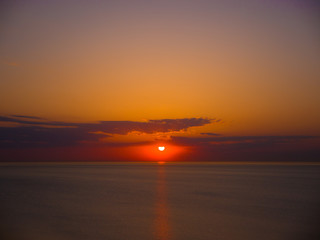Wall Mural - beautiful sunrise photograph with vibrant orange and yellow colors over the dark waters of lake mich
