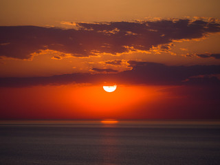 Wall Mural - beautiful sunrise photograph with vibrant orange and yellow colors over the dark waters of lake mich