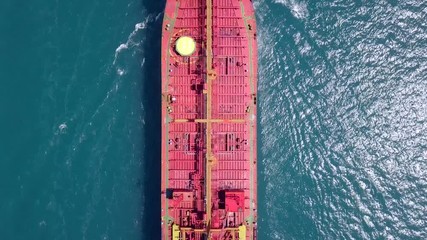 Wall Mural - Aerial footage of a large crude oil tanker approaching a commercial port at the Mediterranean sea.