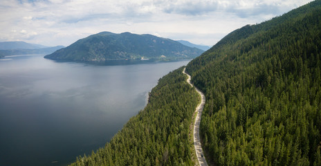 Aerial view of Trans-Canada Highway during a vibrant sunny summer day. Taken near Shuswap Lake, Sicamous, BC, Canada.