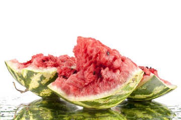 Watermelon on white mirror background in water drops isolated close up