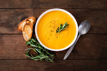 Pumpkin And Carrot  Cream Soup On  Wood Rustic  Background. Autumn Cream-soup In Country Style. Top View. Copy Space.