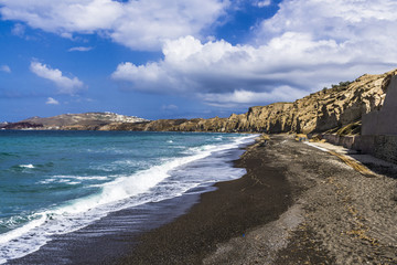 Wall Mural - The black beach is surrounded by rocks