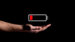 Hand showing Battery Charge icon on black background