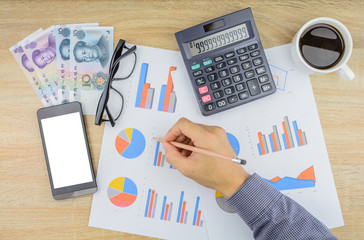 Buisnessman doing financial work at office desk.