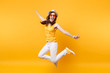 © ViDi Studio - Portrait of excited smiling young jumping high woman in straw summer hat, orange glasses copy space isolated on yellow background. People sincere emotions, passion lifestyle concept. Advertising area.