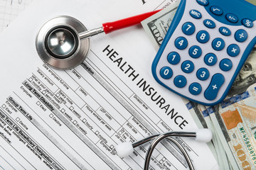 Stethoscope and calculator symbol for health care costs or medical insurance