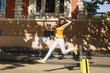 © ViDi Studio - Young overjoyed traveler tourist woman in yellow summer casual clothes, hat with suitcase city map jumping in city outdoor. Girl traveling abroad on weekend getaway. Tourism journey lifestyle concept.