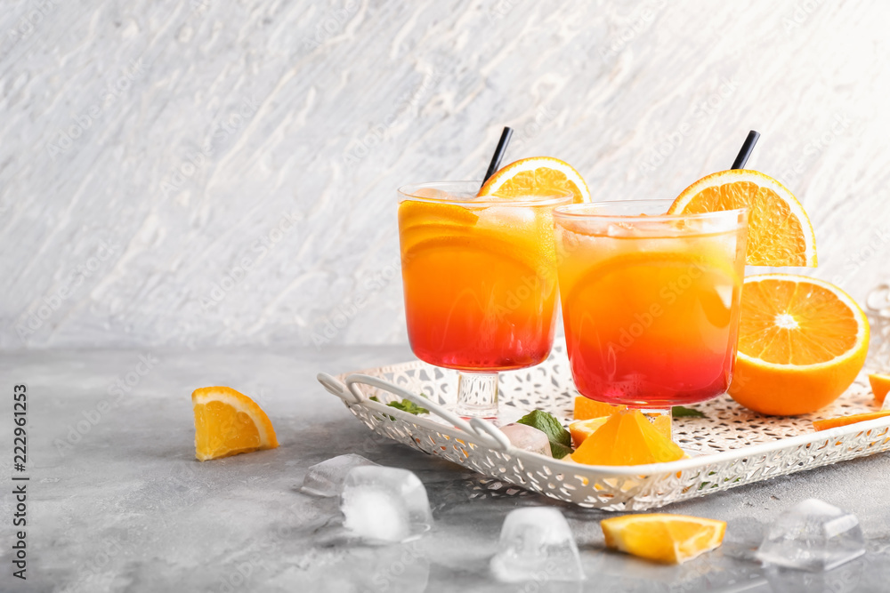 Fresh summer cocktail in glasses on grey table