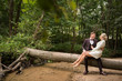 © ADDICTIVE STOCK - Romantic happy couple on tree trunk