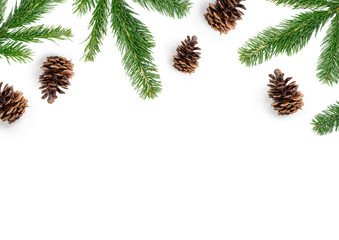 festive Christmas layout composition, top view with fir tree branches and pine cones on a white background.