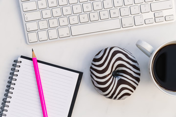 Wall Mural - Computer keyboard notebook coffee donut white background