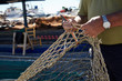 © ADDICTIVE STOCK - Man holding fishing net in hands