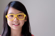© Kenishirotie - Portrait of Asian teenager girl with big yellow glasses