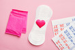 sanitary pads and calendar on pink background, flat lay, top view