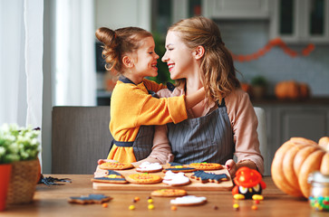 Wall Mural - happy Halloween! family mother and daughter getting ready for   holiday and baking cookies