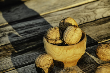 Harvest of a walnut in a garden on a wooden background.