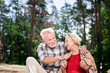 © Viacheslav Yakobchuk - Warm blanket. Cheerful reliable aged man smiling to his retired wife and putting warm blanket on her
