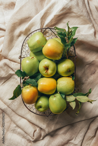 Fotografie, Obraz green apples in metal basket on sacking cloth