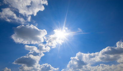 Wall Mural - blue sky with clouds and sun reflection.the sun shines bright in the daytime in summer