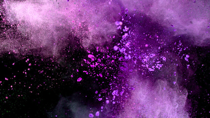 Explosion of coloured powder on black background.