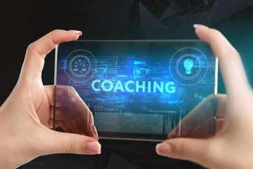 The concept of business, technology, the Internet and the network. A young entrepreneur working on a virtual screen of the future and sees the inscription: coaching