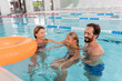 © Viacheslav Yakobchuk - Family activity. Delighted happy parents swimming with their daughter while being in the swimming pool
