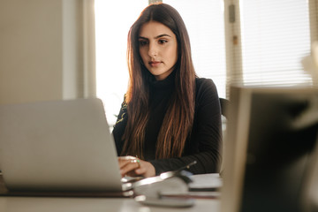 Beautiful young woman working at her desk