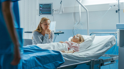 Wall Mural - Sick Little Girl Lying in the Hospital Bed Sleeping, Her Mother Worries  and Prays Beside Her. Emotional and Spiritual Moment Full of Hope.