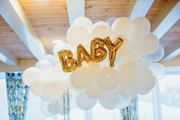 Festive decoration for birthday of baby, many white balloons